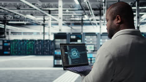 Vertical video Software developer in data center uses AI technology on laptop