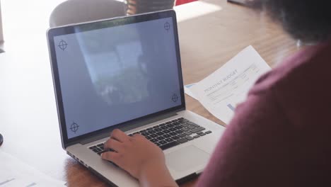 midsection of african american plus size woman using laptop with copy space, slow motion