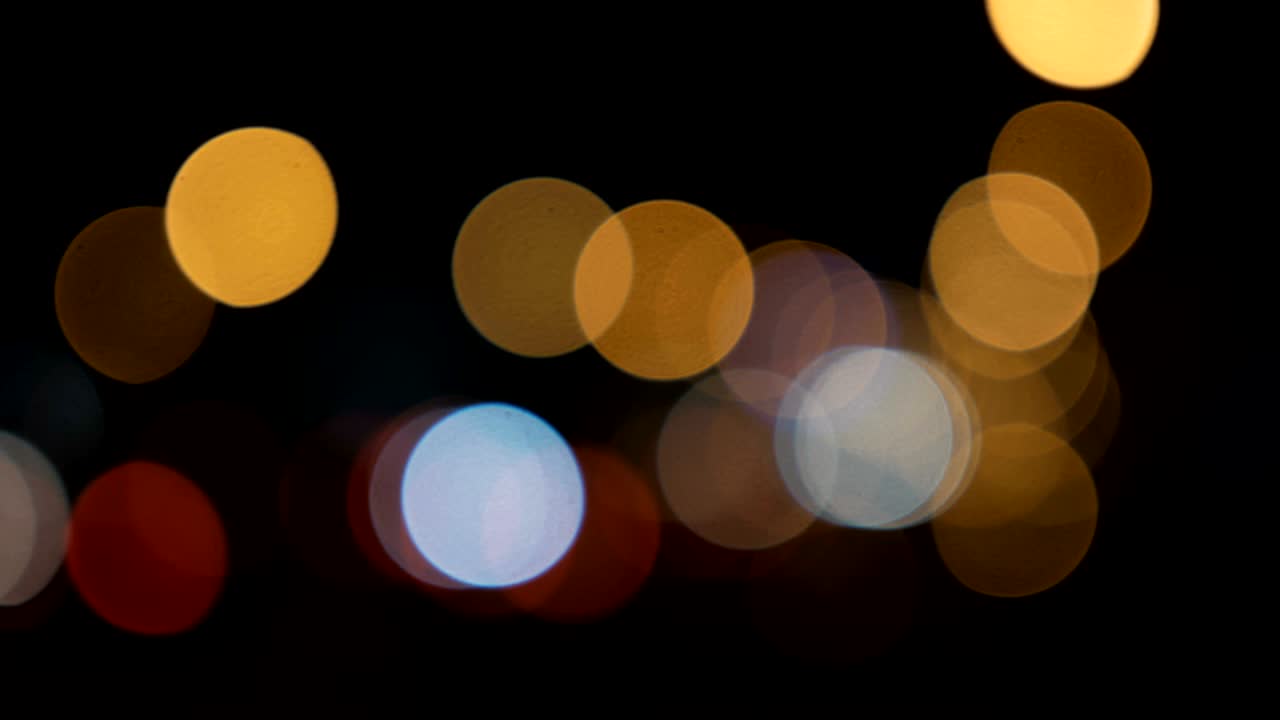 Defocused lights Los Angeles street abstract . City blur background. Moving bokeh circles of night traffic.