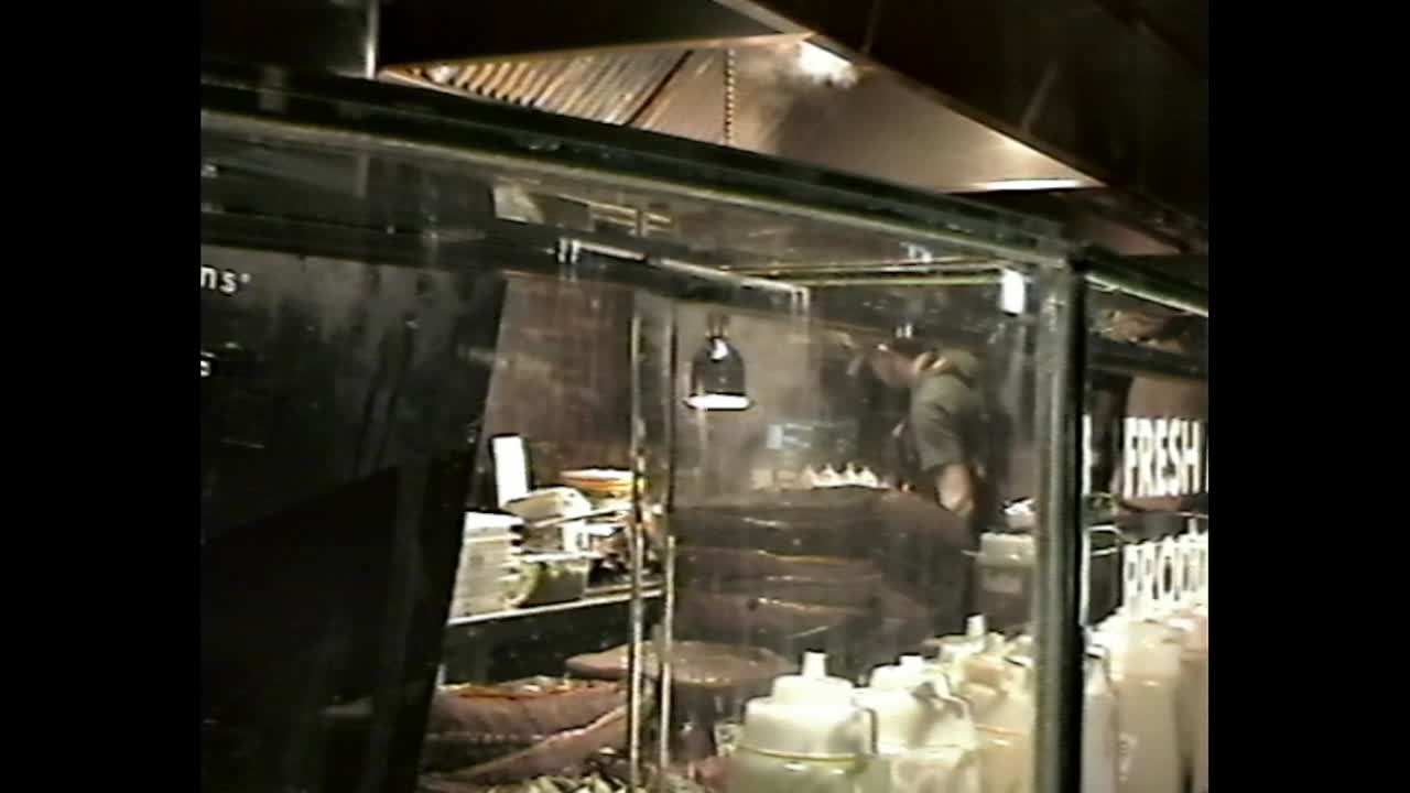Close-up of chefs hands in steamy kitchen line