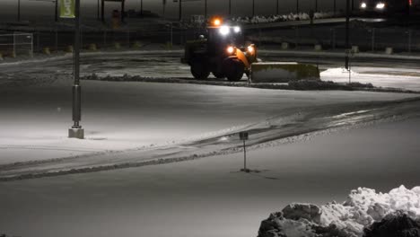 Snowplow-driver-clearing-the-street-in-the-night