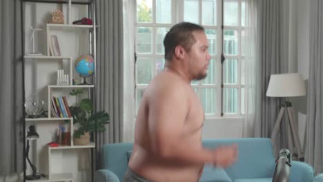 overweight man exercising on treadmill at home