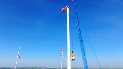 windmill under construction against blue sky - drone shot