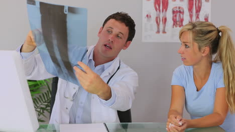 chiropractor discussing with his patient