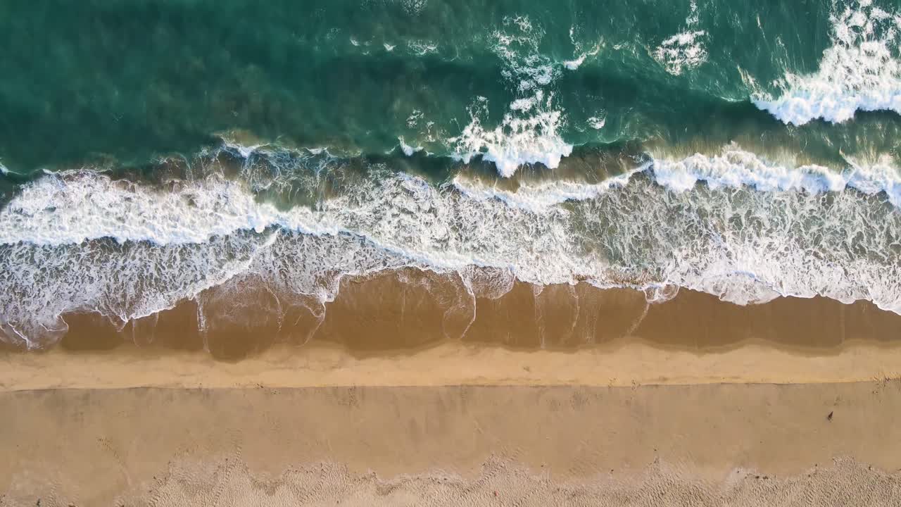 Aerial drone shot of Dhanushkodi’s deserted stretches, framed by shimmering waters on both sides.