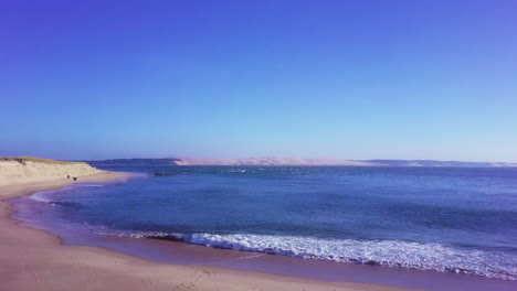 aerial shot dolly in from cap ferret through sea to pyla dune, south france