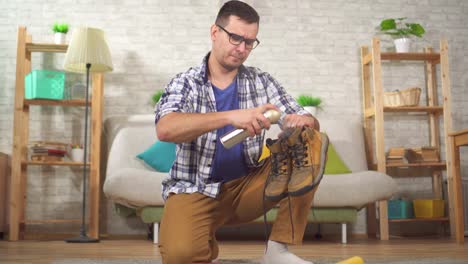 man is engaged in cleaning shoes from dirt with a brush