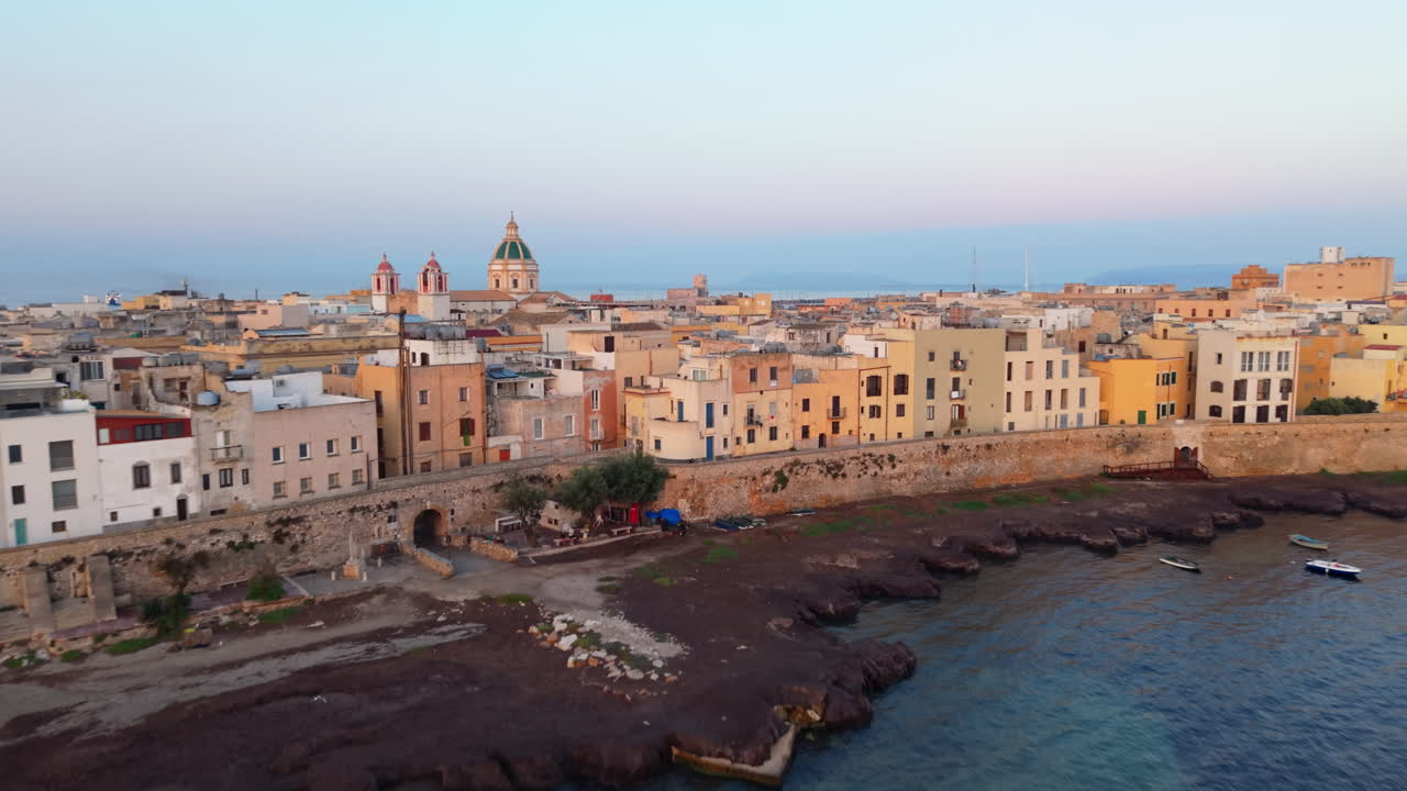 Scenic view of Trapani coastline at sunset with historic buildings