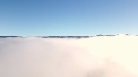 beautiful drone shot ascending from clouds to a sky view