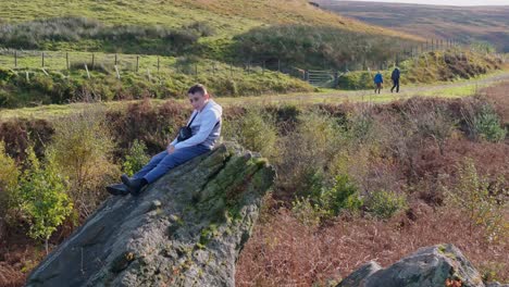 juvenile on vast rock, immersed in contemplation