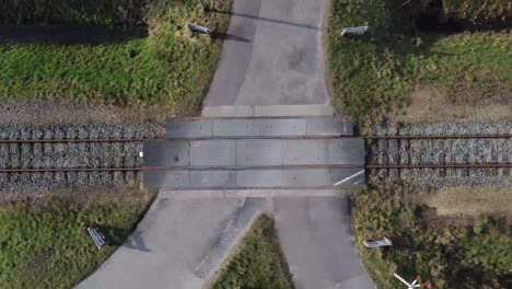 multiple drone shots of railroad with crossing through nature