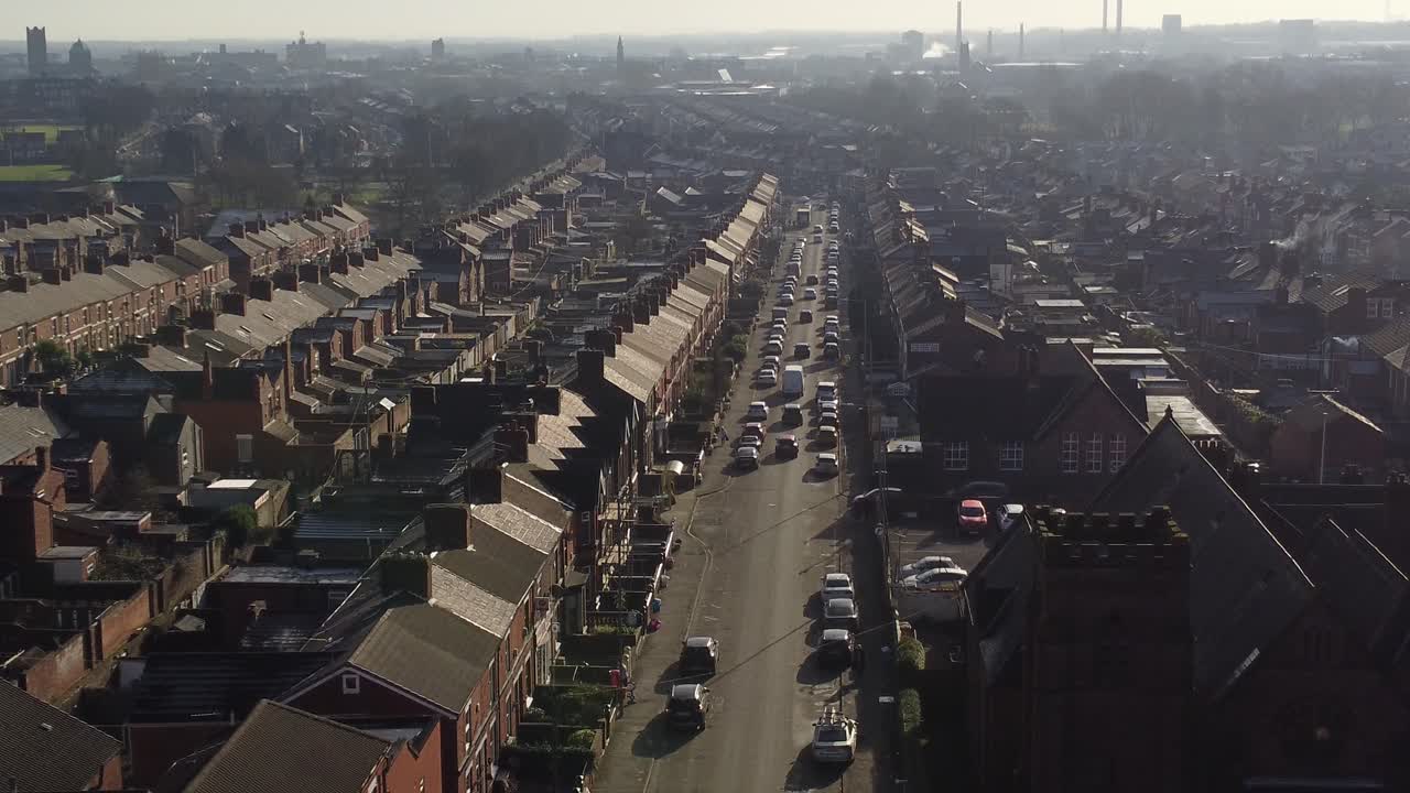 조감도는 번화한 도시 스카이라인으로 이어지는 긴 도로가 있는 세인트 헬렌스 덴톤스 그린에 있는 유서 깊은 계단식 주택을 보여줍니다.