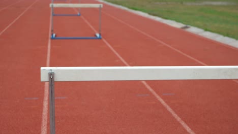 hurdles arranged on a running track at sports venue 4k