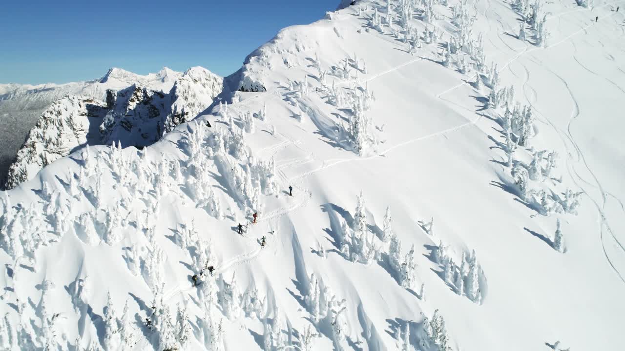 Sciatori che camminano su una montagna innevata 4k