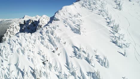 Skiers-walking-on-a-snow-capped-mountain-4k