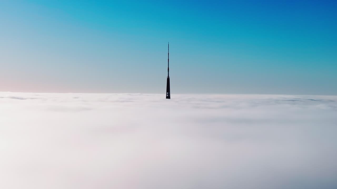 Cinematic morning drone shot shows Riga’s iconic TV tower standing above clouds