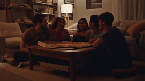 friends eating pizza together at night