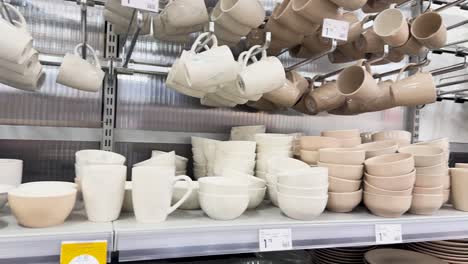 shelves filled with mugs, cups, plates, bowls