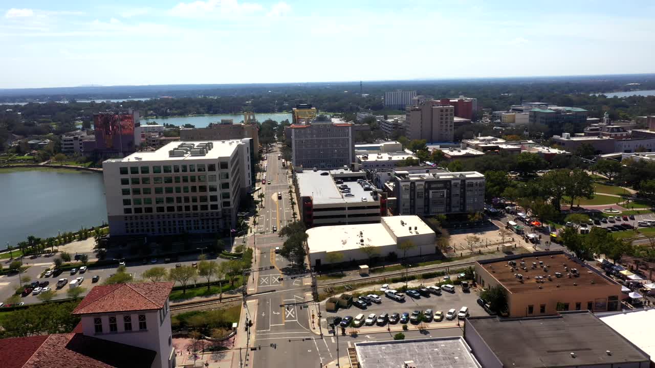 Scenic aerial establishing coastal Winter Haven showing rooftops and bay in soft afternoon light