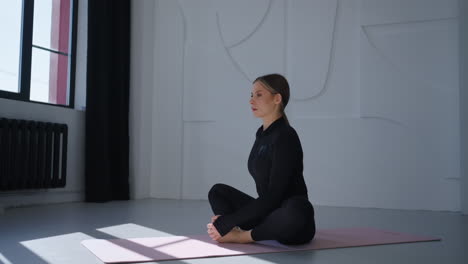 woman practicing yoga in a studio