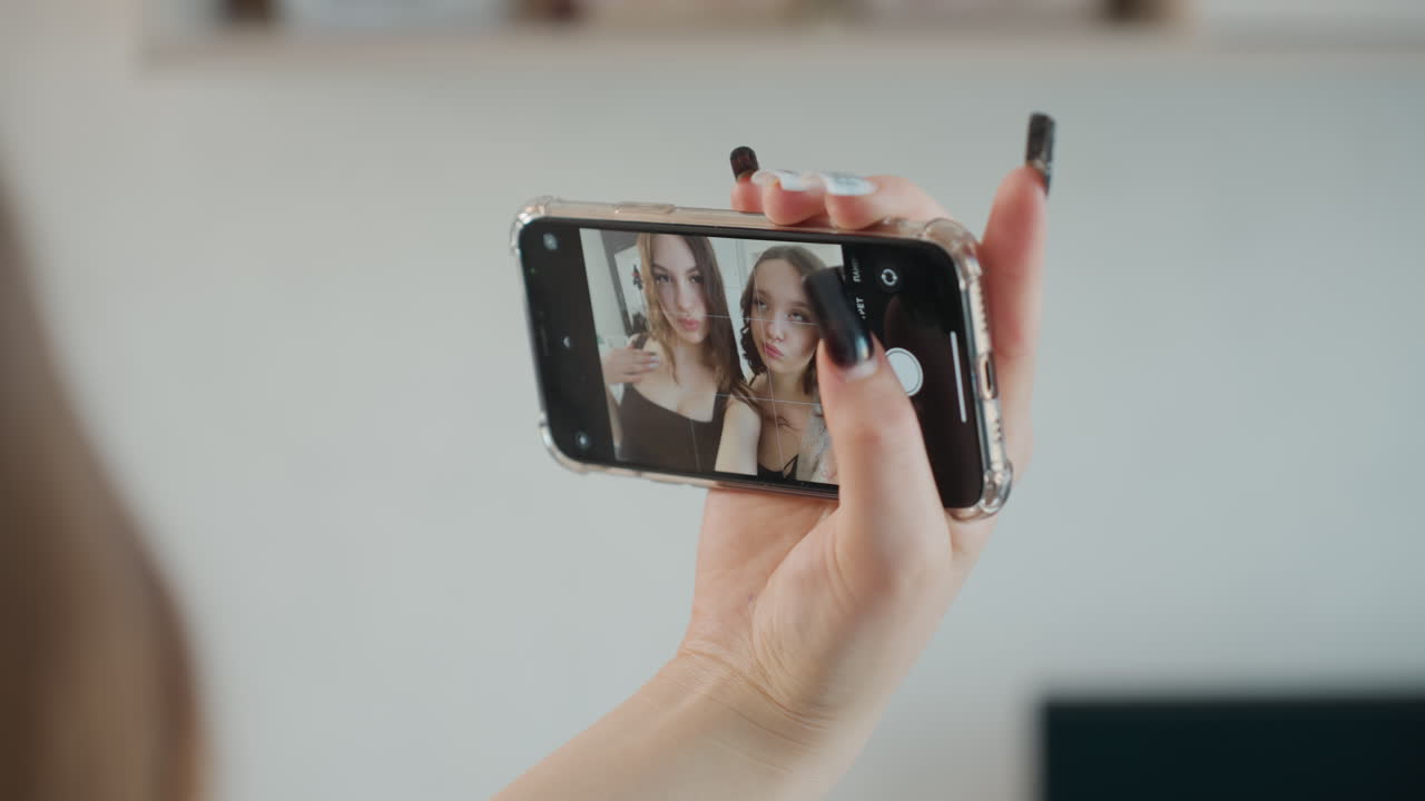 Closeup Of Manicured Hands Gripping Device, Focused Shot Of Hands With Nail Art Grasping Mobile Device, Detailed Image Showcasing Manicured Fingernails Tightly Holding Smartphone In Closeup View