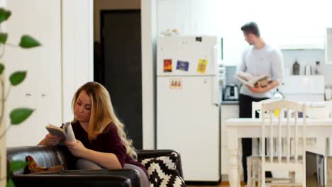 Woman-relaxing-on-sofa-and-reading-book