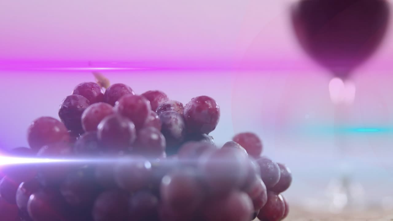 Magenta flare sweeping, camera focusing and shifting view from wine glass to grapes for branding