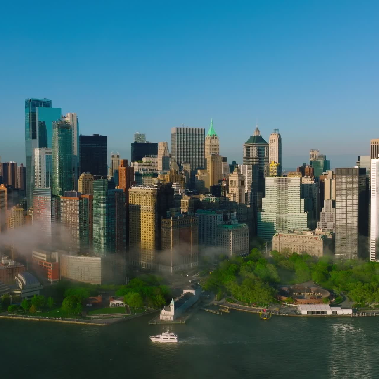 Lower Manhattan Financial District in the light of bright sun. New York city skyline at the backdrop of clear blue sky