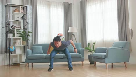 asian man show skill with soccer ball in living room, soccer freestyle
