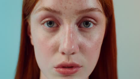 close-up portrait of a woman with red hair and freckles