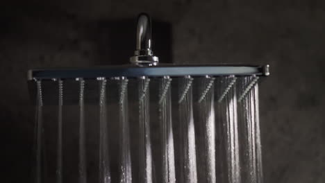 streams of water fall down from the watering can of a modern shower system