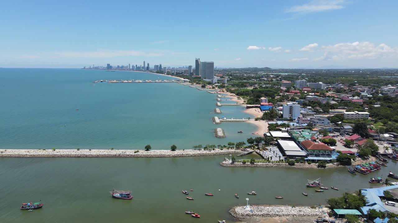 Sattahip Coastline with Pattaya in the Background, Aerial Drone Ascending with Blue Skies Overhead. Thailand.