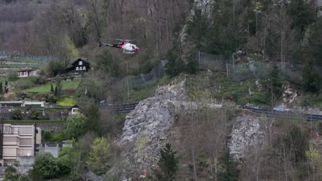 A-rescue-helicopter-facing-challenges-during-a-rescue-operation-in-Wessen,-Switzerland