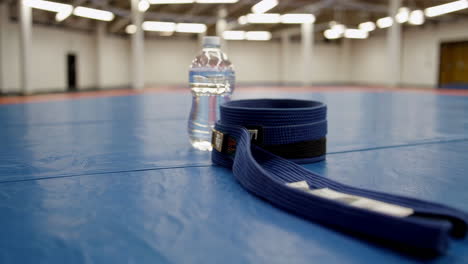 martial arts blue belt and water bottle