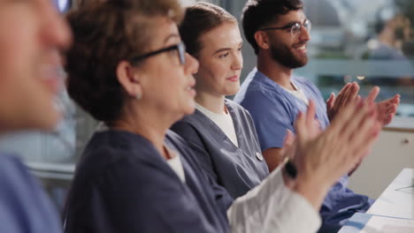 medical professionals clapping at a conference