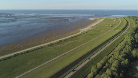 aerial view of traffic on coastal road by rural north sea beach, germany