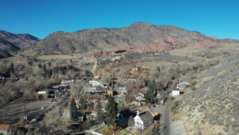 A-pull-back-of-beautiful-Morrison-Colorado,-Red-Rocks-settles-in-the-distance