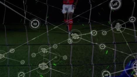 Animation-of-network-of-digital-icons-over-rear-view-of-caucasian-male-goalkeeper-making-a-save