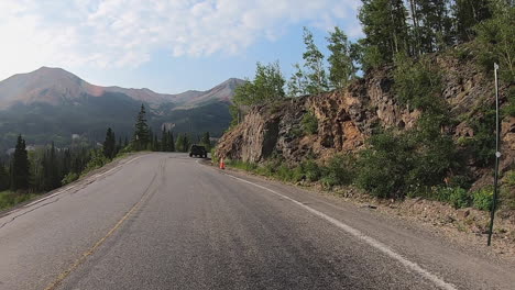 pov while driving on million dollar highway following mineral creek with dramatic views of san juan mountains