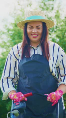 a joyful gardener in action: capturing the essence of gardening with a smiling woman in a straw hat and colorful gloves engaged in her gardening duties