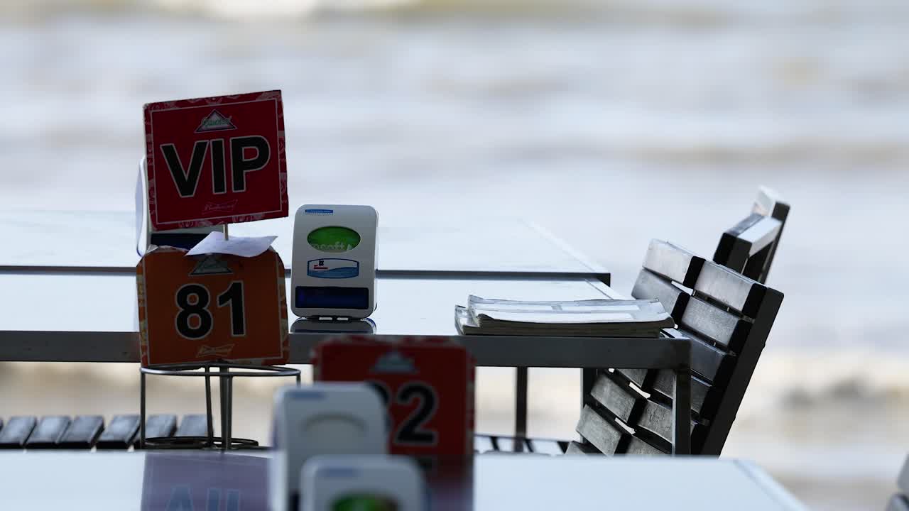 Quiet seaside dining setup with reserved tables