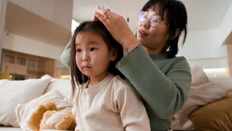 mother styling daughter's hair
