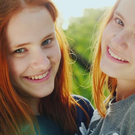 close-up portrait of two happy sisters twins