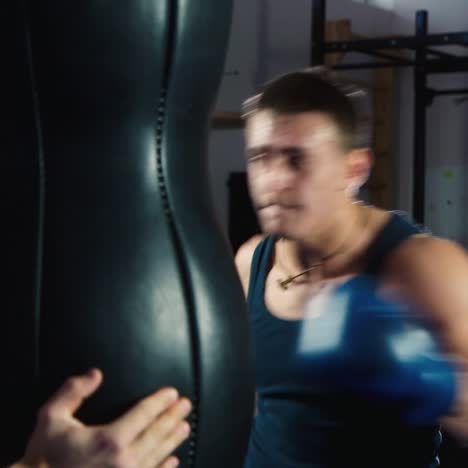 a young boxer practices punches on a punching bag 3