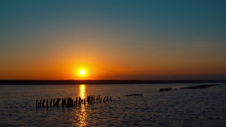 Panoramic sea view with calm peaceful beach in background. Late evening sunset.