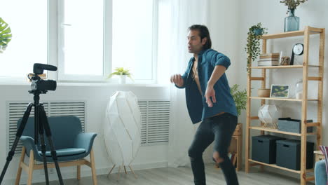 man dancing for vlog recording at home