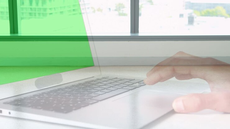 Animation of hands using laptop with green screen over sped up commuters walking in modern building