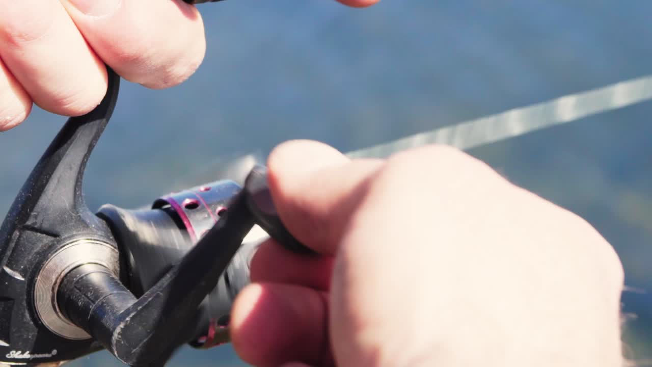 Fishing rod reeling in fish in the middle of the lake