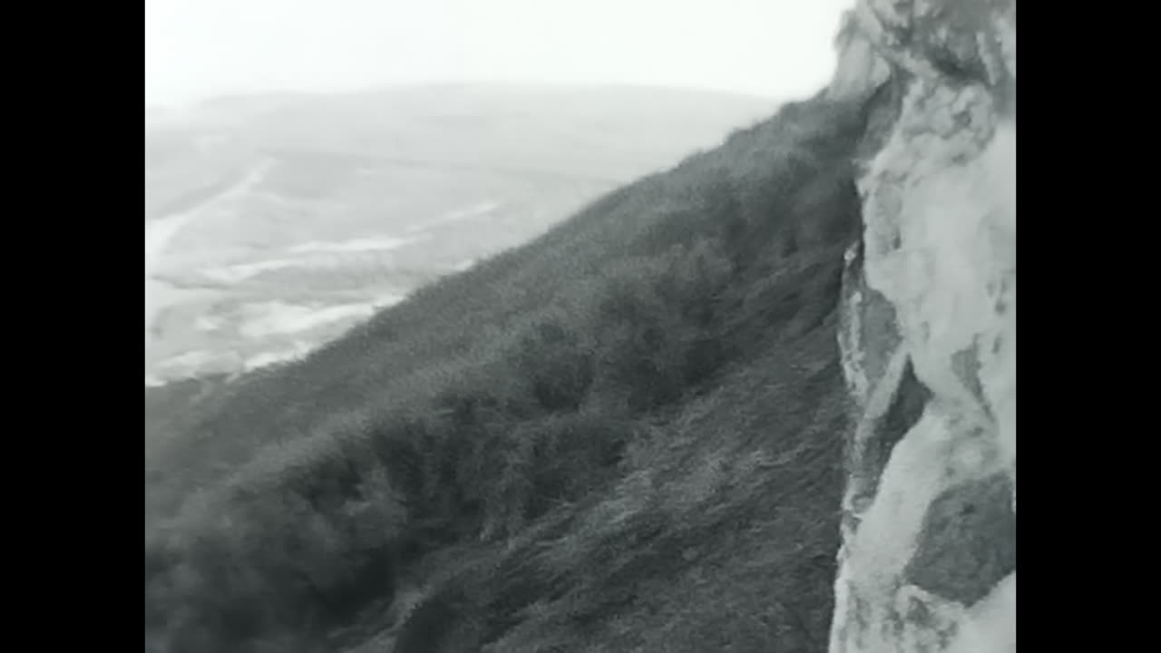 Man Standing Next to Wall, A Captivating Black and White Video From the USSR Archive. CIRCA USSR 1970: This interesting video showcases a man standing beside a wall, providing a glimpse into the lives of Soviet people during the era of communism and socialism.