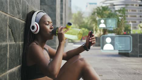 animation of network of icons over african american woman using smartphone